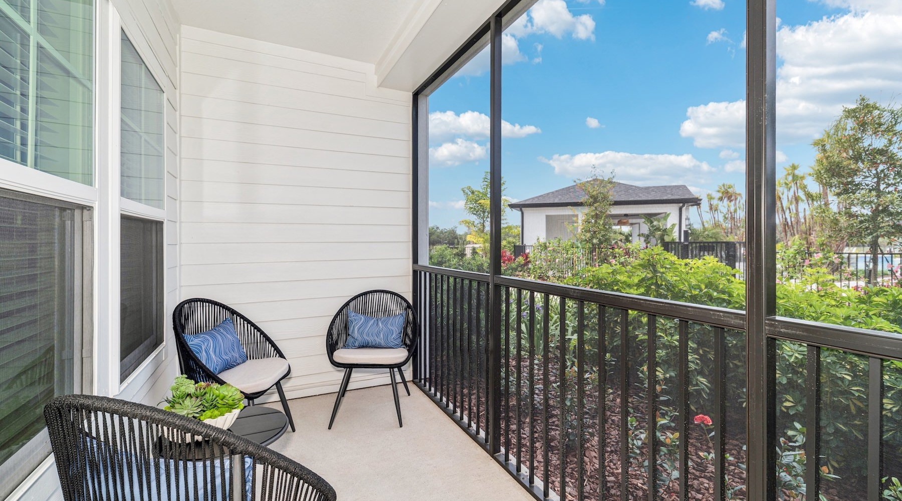a patio with chairs and a table