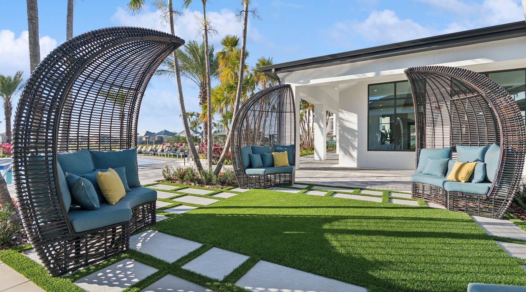 a patio with chairs and shading