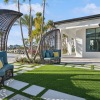 a patio with chairs and shading