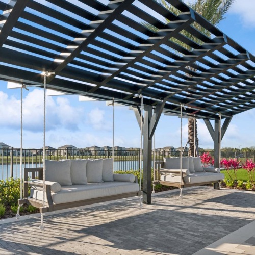 Relax and unwind poolside a covered area with swinging benches